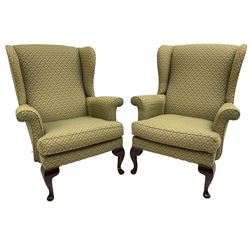 Pair of late 20th century hardwood-framed wingback armchairs, upholstered in green and gold fabric, on cabriole front feet 