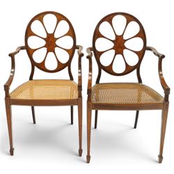 Hampton & Sons (Pall Mall 1830-1957) - Pair of Edwardian inlaid mahogany wheel-back elbow chairs, the pierced oval backs with chequered stringing and cross banding, out-swept arms over canework seats, banded seat rail over square tapering supports with spade feet, stamped to underside
Provenance: Kirkham Hall