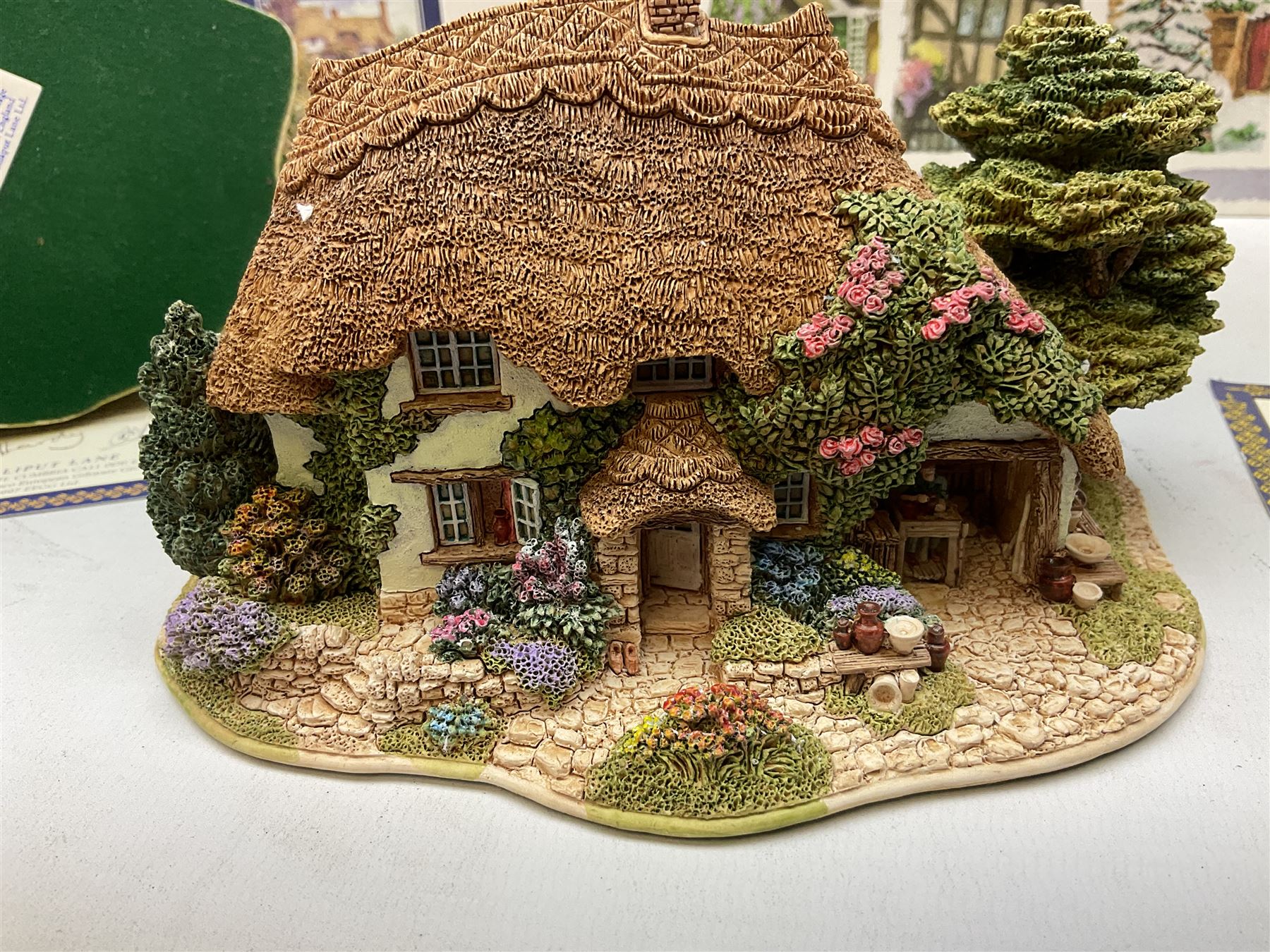 Eight Lilliput Lane models, including Gertrude's garden, Cruck End, Honeysuckle cottage, The Pottery, Huddersfield Railway Station, The Magpie Cafe, Amberly Rose, Summer Days and Shades of Summer, all boxed with deeds