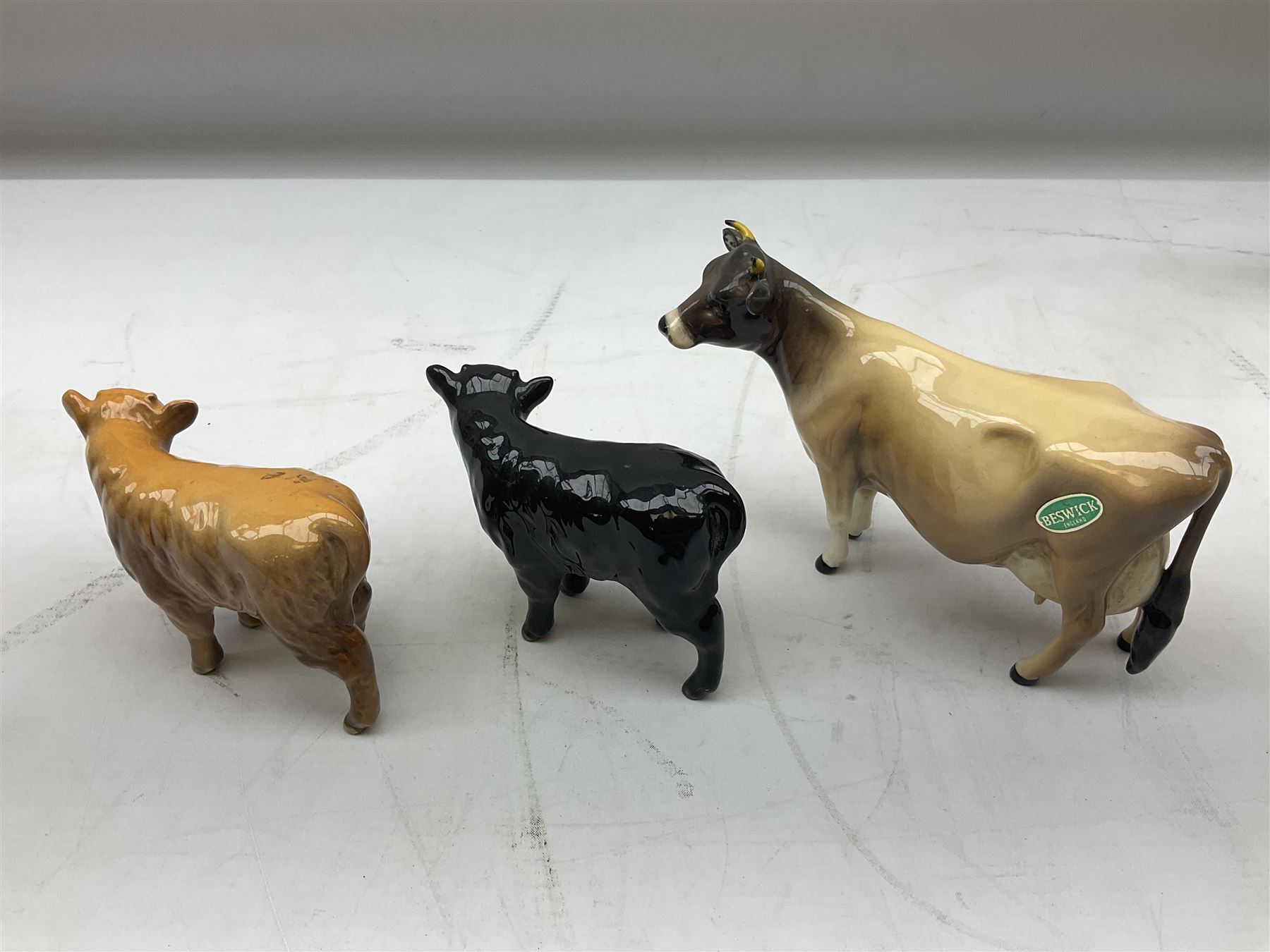 Seven Beswick cow figures, to include Friesian bull Ch. ''Coddington Hilt Bar'' no. 1439a, Friesian cow Ch. 'Claybury Leegwater' no. 1362a and Friesian calf no. 1249C, Aberdeen Angus calf 1827a, Jersey cow no. 1345 etc, all with printed mark beneath  