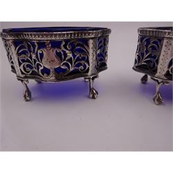 Pair of Victorian open silver salts with pierced sides, upon four ball and claw feet, hallmarked George Nathan & Ridley Hayes, Chester 1900, H5.2cm, each with blue glass liner