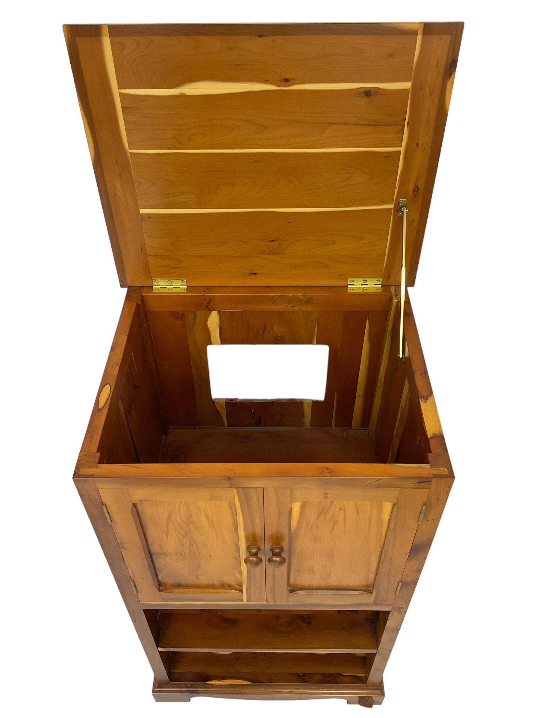 Unicornman - yew wood cabinet, moulded hinged lid over two panelled doors and shelves (W56cm, H99cm, D45cm); and four Unicorn man CD racks two in yew wood and two in oak (W20cm, H36cm, D20cm); all carved with unicorn signature and by Geoff Gell, Coxwold
