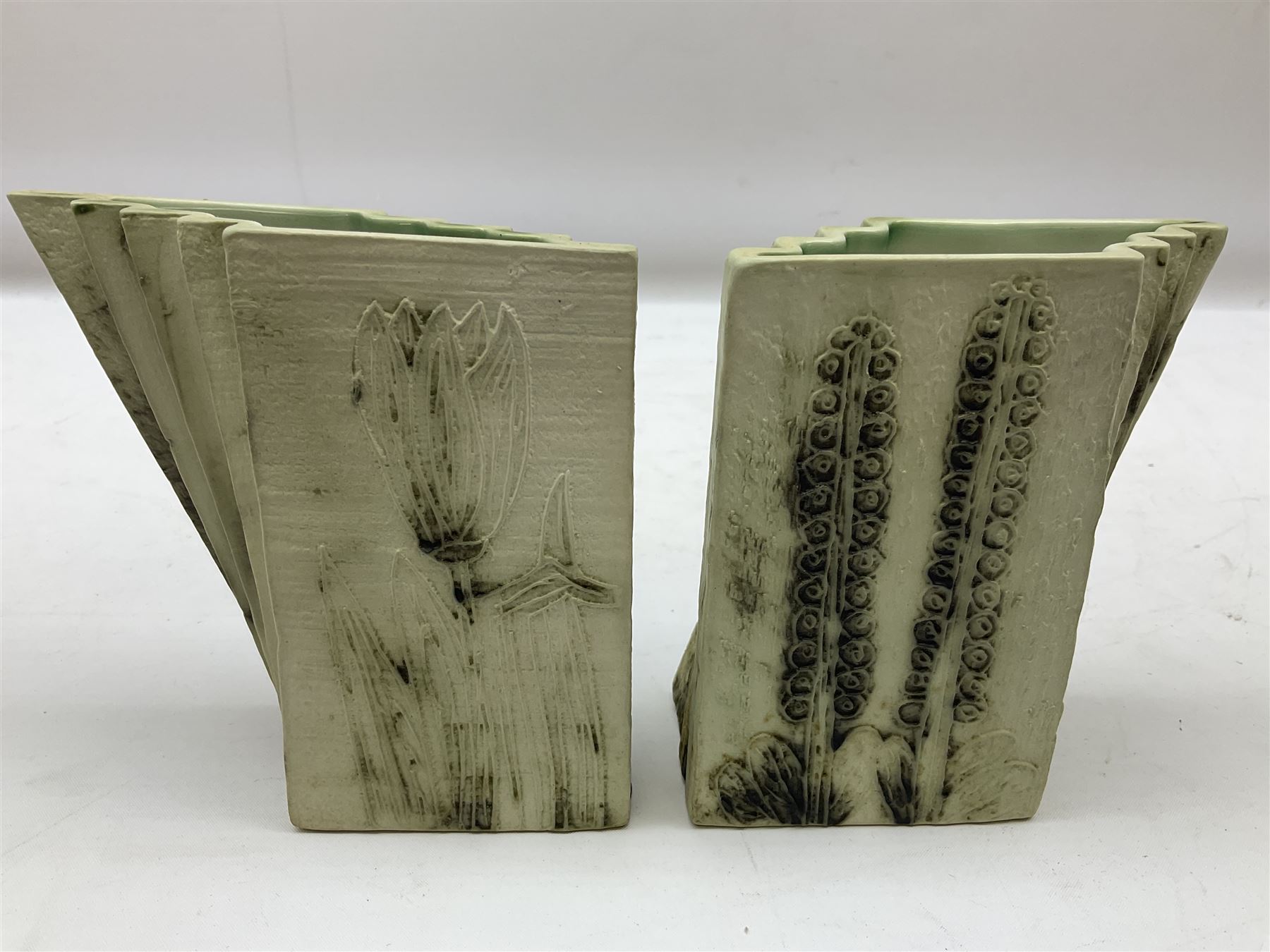 Pair of Carn Pottery Penzance vases of fan form, with tube lined floral and stylised decoration, stamped and marked X9 to base, H11.5cm