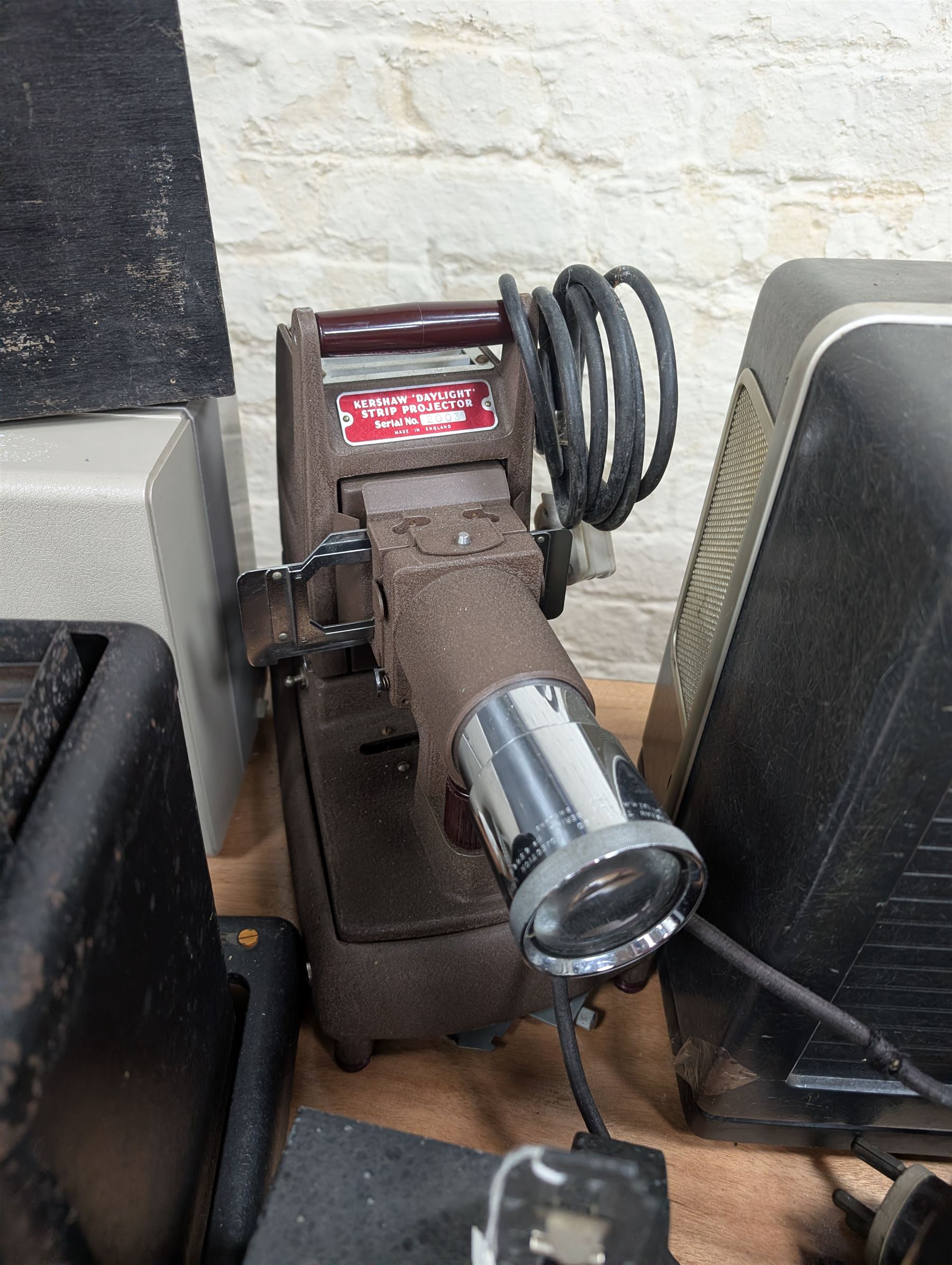 Ten vintage projectors, including Bell & Howell 1623x, Kershaw Daylight Strip projector, Aldis, Leitz, Pathoscope Ace, Ray Safety Cinema, Baby Projector and Pullin Optics