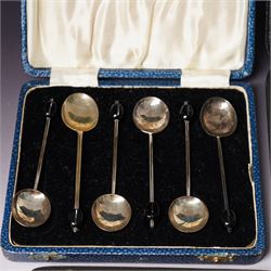 Set of six silver coffee spoons with shaped terminals, cased London 1924, another set of similar spoons London 1924 cased and a set of six silver bead knop spoons Birmingham 1936, cased
