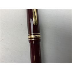 Mont Blanc Meisterstuck fountain pen, the burgundy lacquer body with gilt band detail, signed 'Montblanc-Meisterstuck', with 14kt gold nib, serial number EK1120925