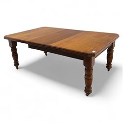 Victorian mahogany extending dining table, rectangular top with chamfered corners above a plain frieze raised on turned reeded legs with castors and two additional leaves, 197cm fully extended, and a set of six early 20th century oak upholstered chairs with drop-in seats, arched panelled back splat and close studded border on turned front legs joined by stretchers, 47x41x109cm 