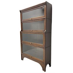 Kenric Efferson - early 20th century mahogany four-tier library bookcase, enclosed by four glazed up-and-over doors, on bracket feet