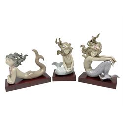 Lladro Mermaid trio set, comprising Illusion no. 1413, Fantasy no.1414 and Mirage no. 1415, all with wooden bases, largest H20cm