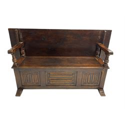 Jacobean design oak Monks bench, the front with carved linenfold panels, hinged metaphoric table back, hinged box seat compartment, on sledge feet