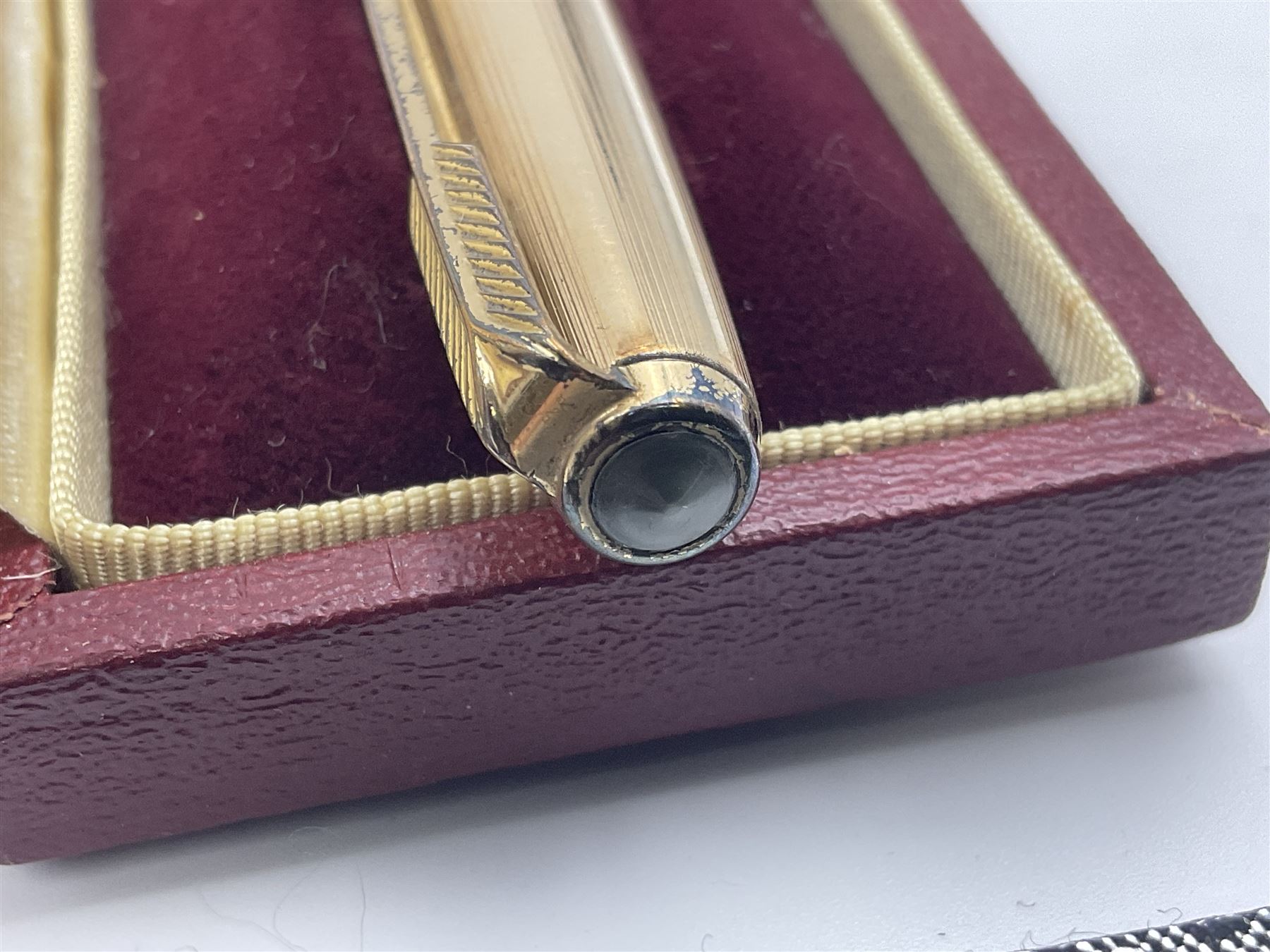 Three rolled gold Parker fountain pens, comprising an example with a gold nib marked 14K 585 and barrel with a shell stamp, a Parker 61 fountain pen with inset gold arrow to the nib, and another similar, all with striated decoration and arrow clips to the caps, L13cm, one with box