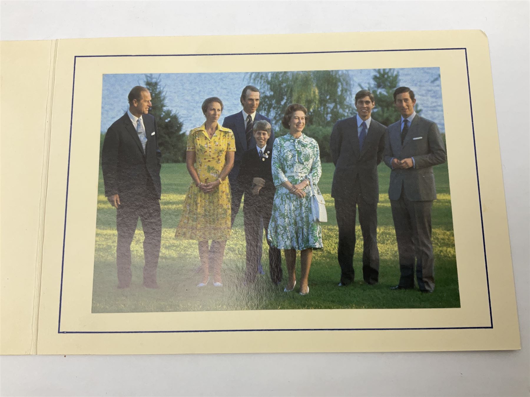 H.M. Queen Elizabeth II and H.R.H. The Duke of Edinburgh, signed 1976 Christmas card with twin gilt Royal cyphers to cover, colour photographic print of the Royal Family to interior, and signatures Elizabeth R and Philip with the manuscript date 1976 below