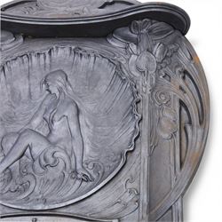 Art Nouveau cast iron fireplace, shaped hood with scrolling foliate crest, relief cast panel of female figure seated within shell form amidst wave motifs, uprights cast with foliate designs