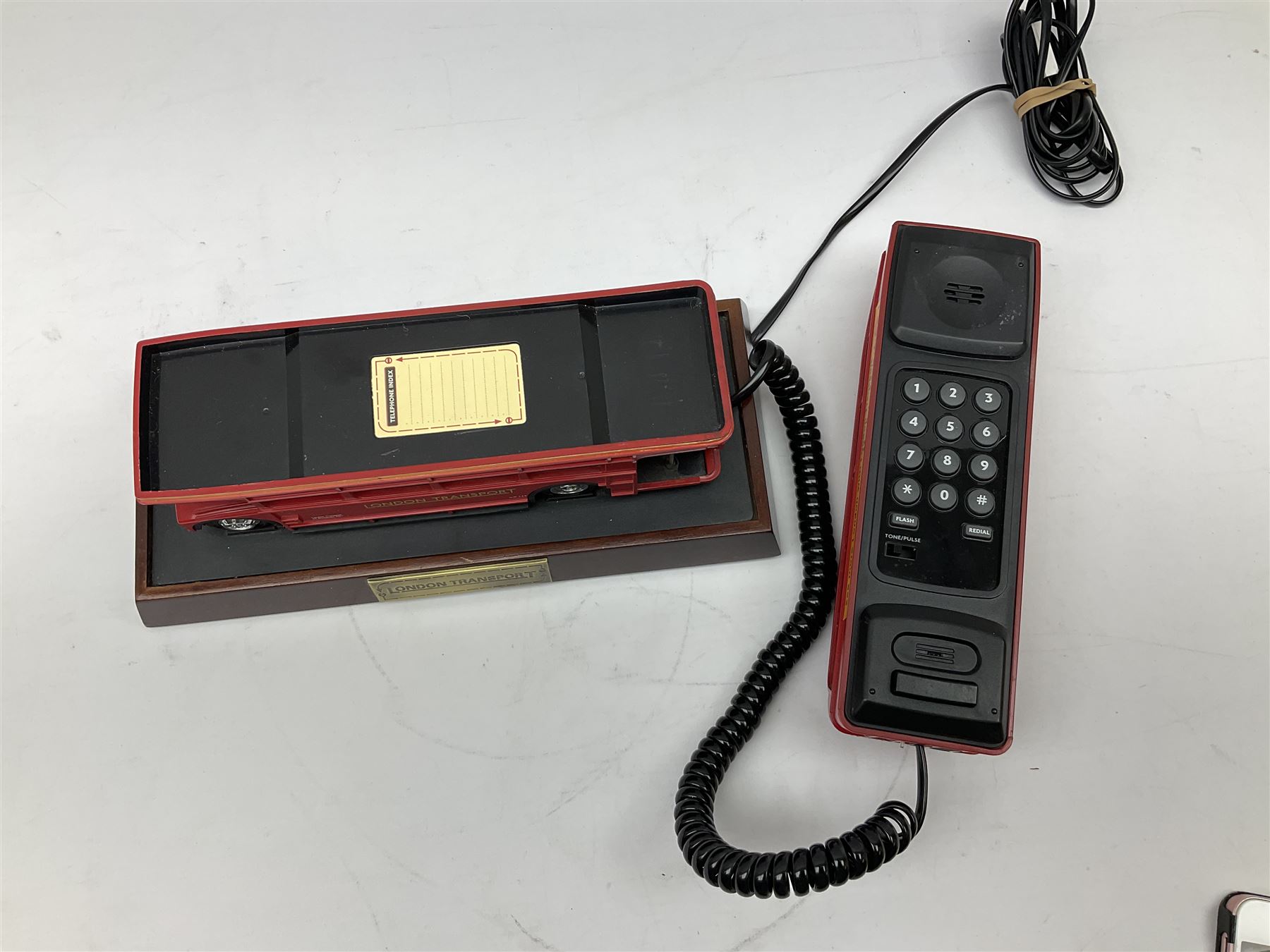 Novelty telephone in the form of a London Routemaster bus, c1997, fitted on wooden plinth with modern connection L25.5cm