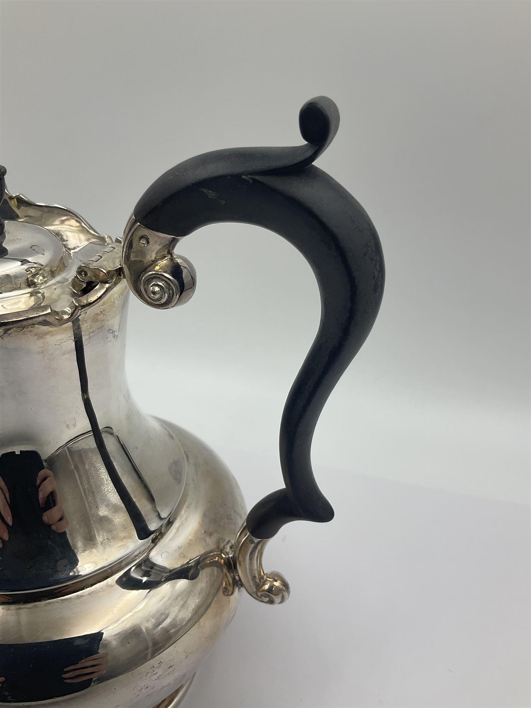 1920s five-piece silver tea service, comprising teapot, coffee pot, hot water pot, twin handled open sucrier and milk jug, each of squat circular form with shaped rim, the teapot, coffee pot and hot water pot each with ebonised handle and finial, the sucrier and milk jug with acanthus capped scroll handles, all upon circular foot, hallmarked R F Mosley & Co, Sheffield 1926 & 1927, tallest H24cm