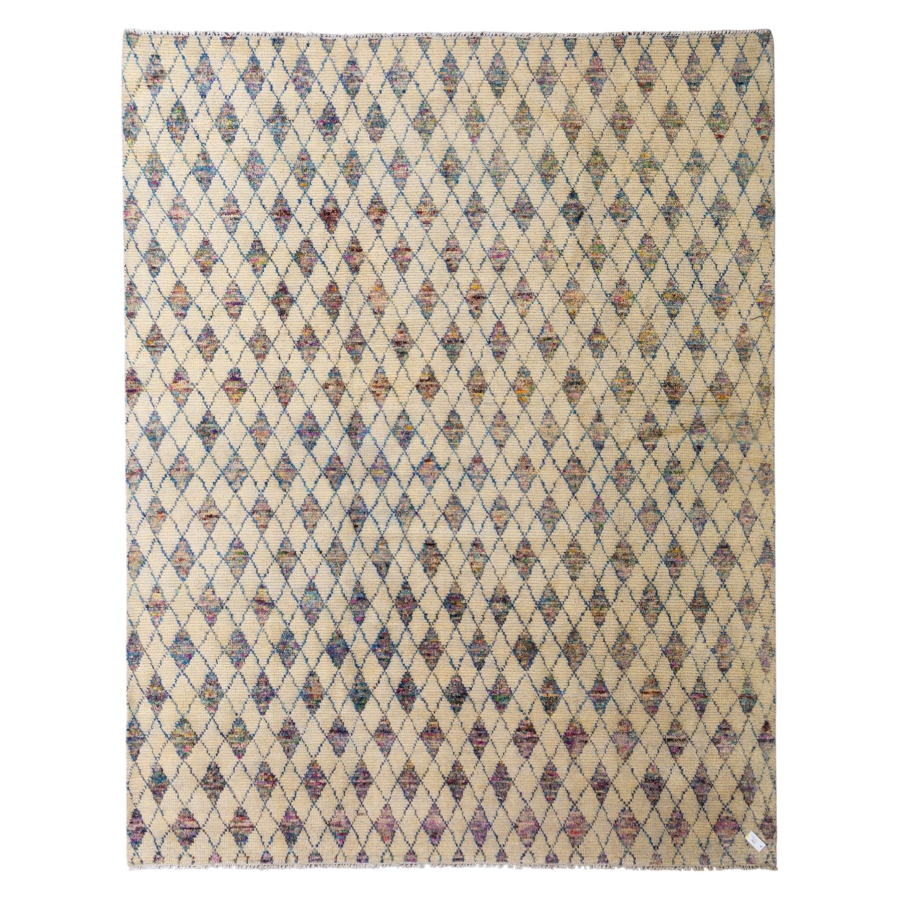 Contemporary Moroccan Berber design wool rug, cream field with blue diamond lattice, decorated with repeating multicoloured lozenge motifs, short fringe ends and bound sides