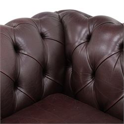 Thomas Lloyd - traditional shape Chesterfield two seater settee with rolled back and arms, upholstered in buttoned deep oxblood leather with loose seat cushions, raised on turned feet