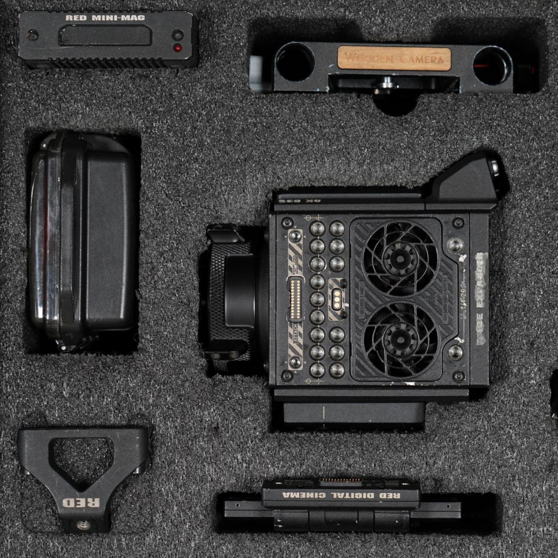 RED Epic-W Helium 8K camera body serial no. 13024E6A9, with RED EVF, three RED Mini Mag 512GB cards, one 480 Mini Mag card and reader, two RED V-Mount batteries and charger, RED top handle, Wooden Camera Easy Top top plate and one other top plate, various accessory cables, Wooden Camera bridge plate for 19mm studio rods, 12 inch Wooden Camera Dovetail plate and four 19mm studio rods to include two 380mm and two 610mm, with original Epic-W camera box and contained within a custom cut flight case
