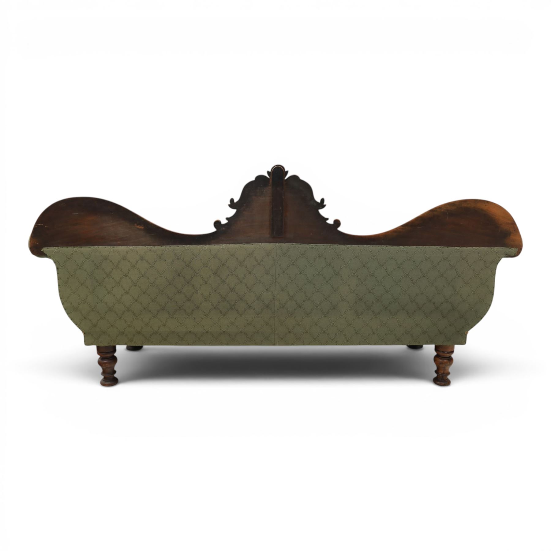 Victorian mahogany framed sofa, scroll arms with double camel back, green geometric upholstery, raised on turned supports