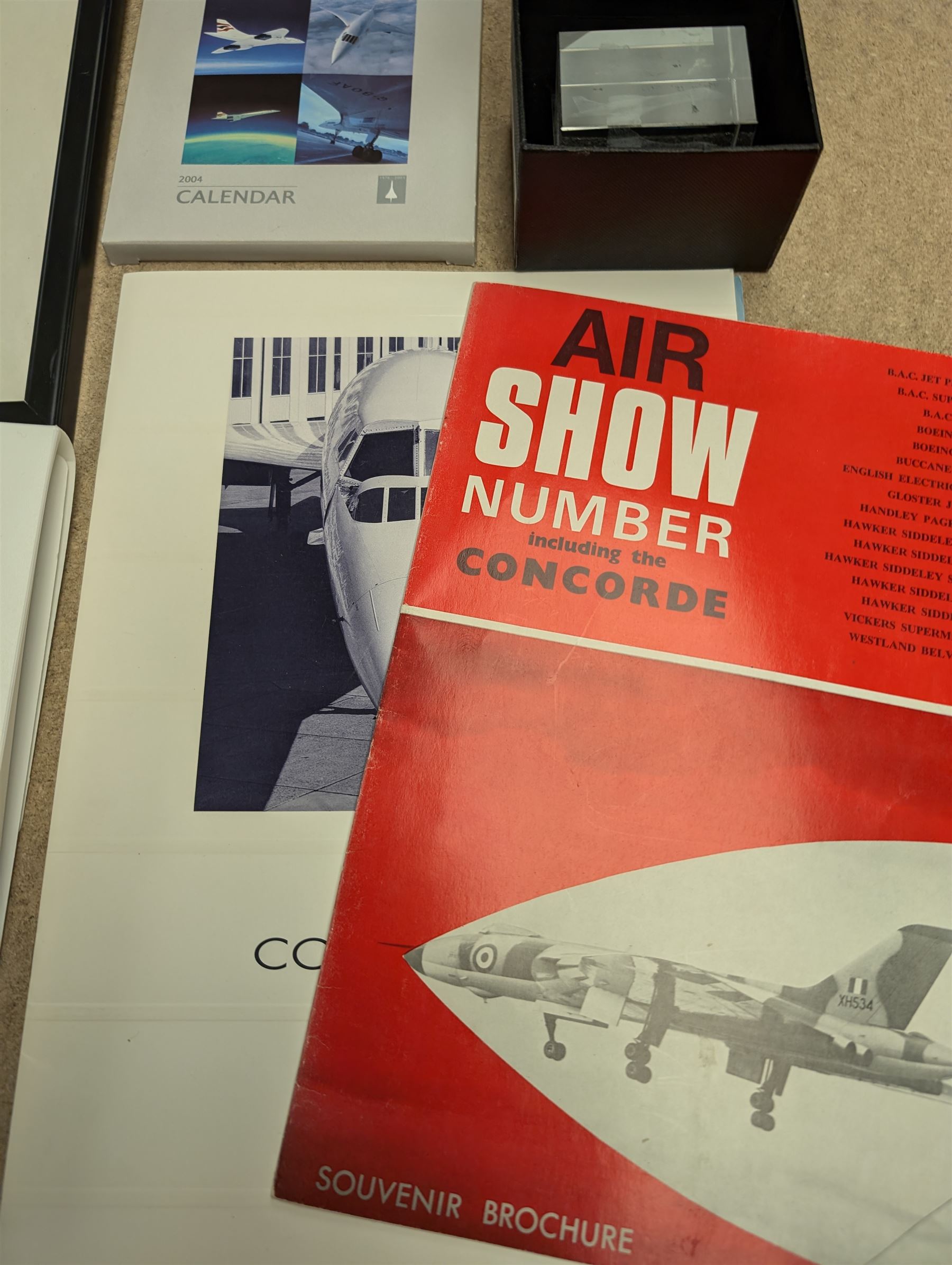 Collection of Concorde memorabilia, including paperweight, limited edition print, calendars, scale model, etc 