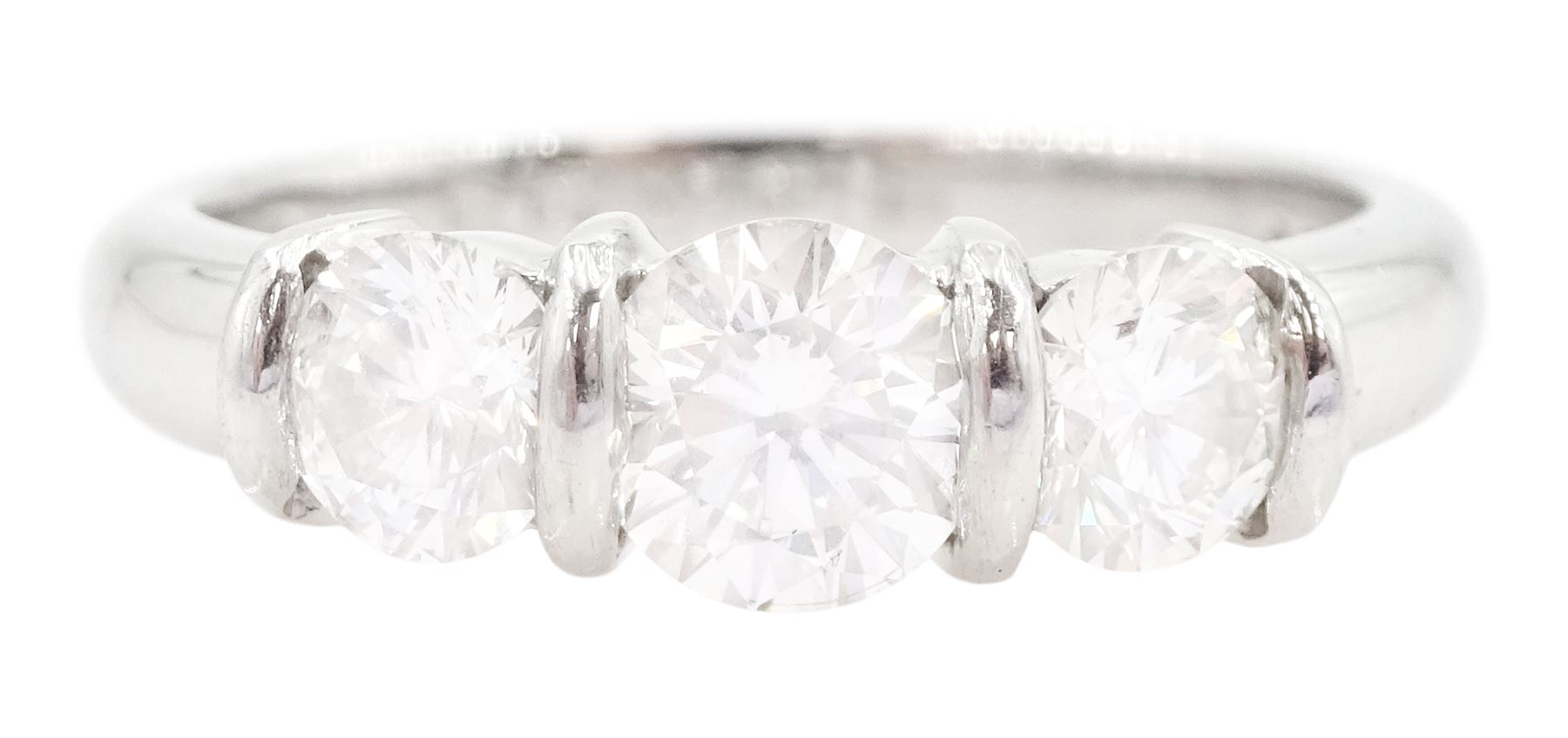 Platinum three stone round brilliant cut diamond ring by FEU, London 2003, total diamond weight 1.03 carat