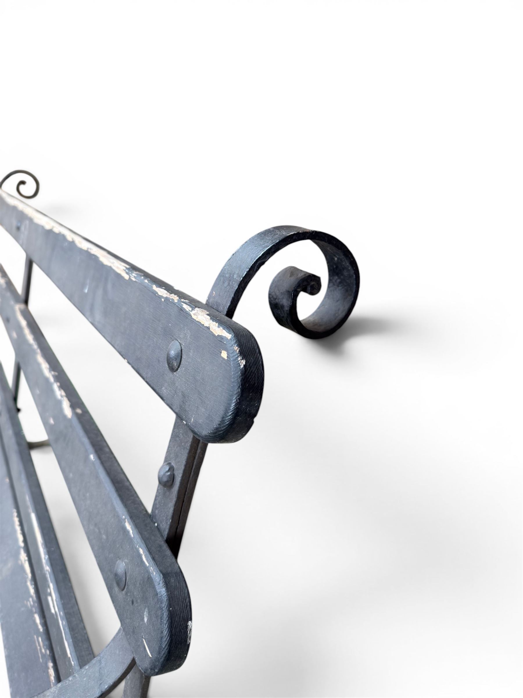 Coalbrookdale - rare pair of wrought iron and slatted wood garden benches, the twin wrought iron strapwork bench-ends formed of four scrolls over splayed feet, number 77 in the Coalbrookdale Castings Catalogue (see illustration)