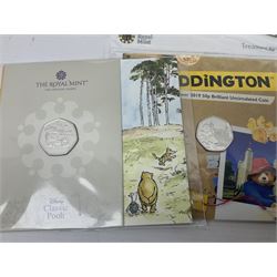 Seven The Royal Mint United Kingdom brilliant uncirculated commemorative fifty pence coins, including 2018 'Paddington at the Palace' etc, each housed on card