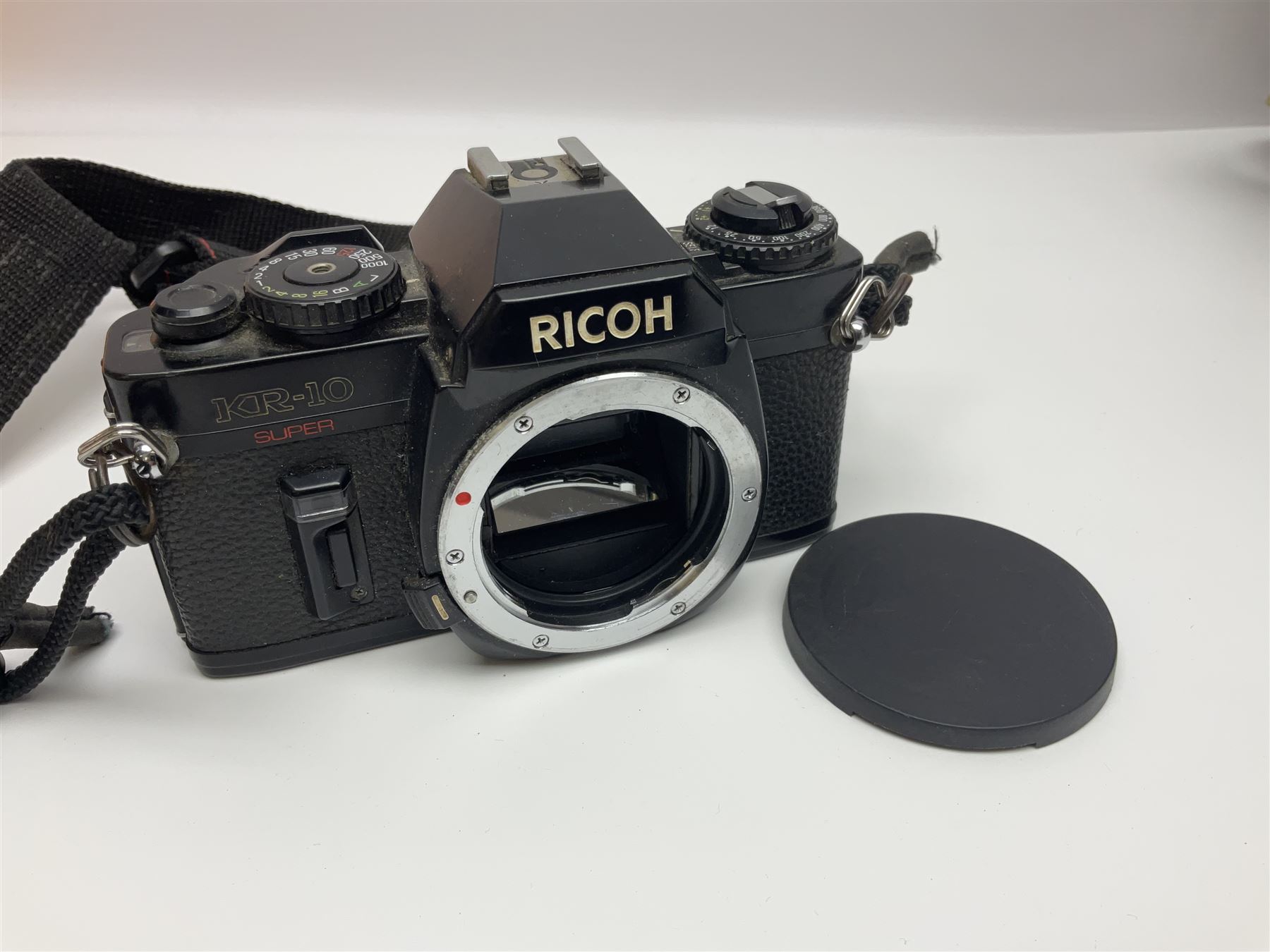 Four camera bodies, to include, Ricoh KR-10 serial no. 38826, Pentax MZ-M serial no. 4185969 with 'SMC Pentax- M 1:3.5 28mm' lens, Canon EOS500 serial no. 080927, with 'Sigma Zoom 100-300mm 1:4.5-6.7 DL'  lens etc, with other camera lenses and equipment 