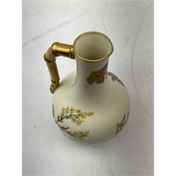 Late 19th century Royal Worcester blush ivory ewer decorated with floral sprays and gilt, with angled bamboo handle, artist monogram BK and printed mark for 1889 beneath, H17cm