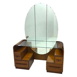 Early 20th century Art Deco walnut dressing table, featuring a large oval triptych mirror above a stepped base, fitted with four drawers and a central glass shelf, all raised on a plinth base