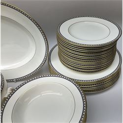 Wedgwood tea and dinner wares decorated in the Black Ulander pattern, comprising nineteen dinner plates, eighteen salad plates, eighteen side plates, twenty four bowls, two tureen and covers, sauce boat and stand, three oval platters, and six coffee cans and six saucers. 