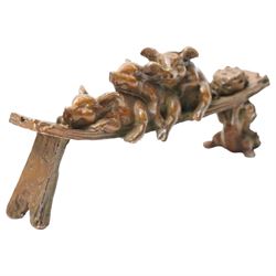 Bronze figure of three pigs resting on a bench, W10cm 