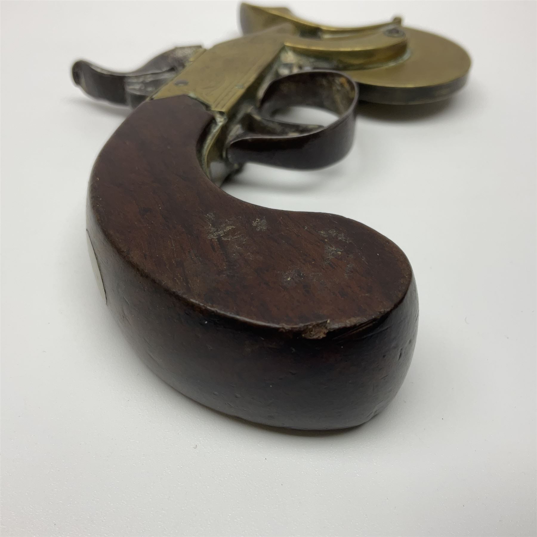 19th Century percussion eprouvette or gunpowder tester, with foliate engraved brass box lock and calibrated ratcheted wheel, steel trigger guard and walnut bag butt, L14cm