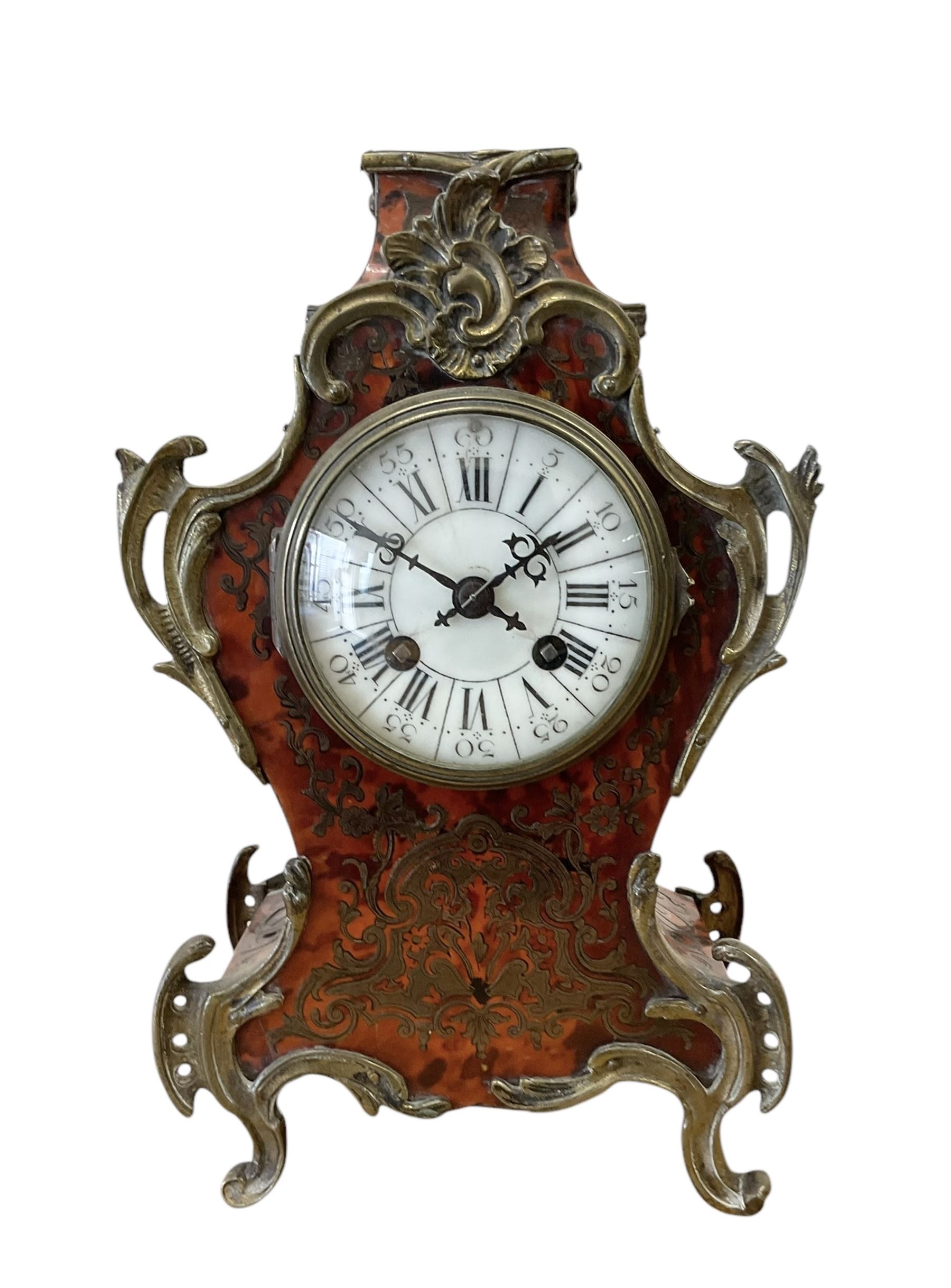 French- late 19th century 8-day Boulle mantle clock with rococo brass mounts, enamel dial with segmented Roman numerals, five-minute Arabic's and matching steel hands, Parisian rack striking movement sounding the hours and half hours on a bell. With pendulum and key. 