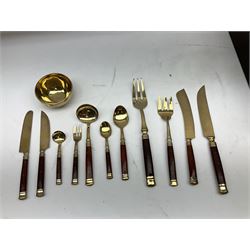 Thai canteen of cutlery, gilt with wood handles, the interior lined with green velvet