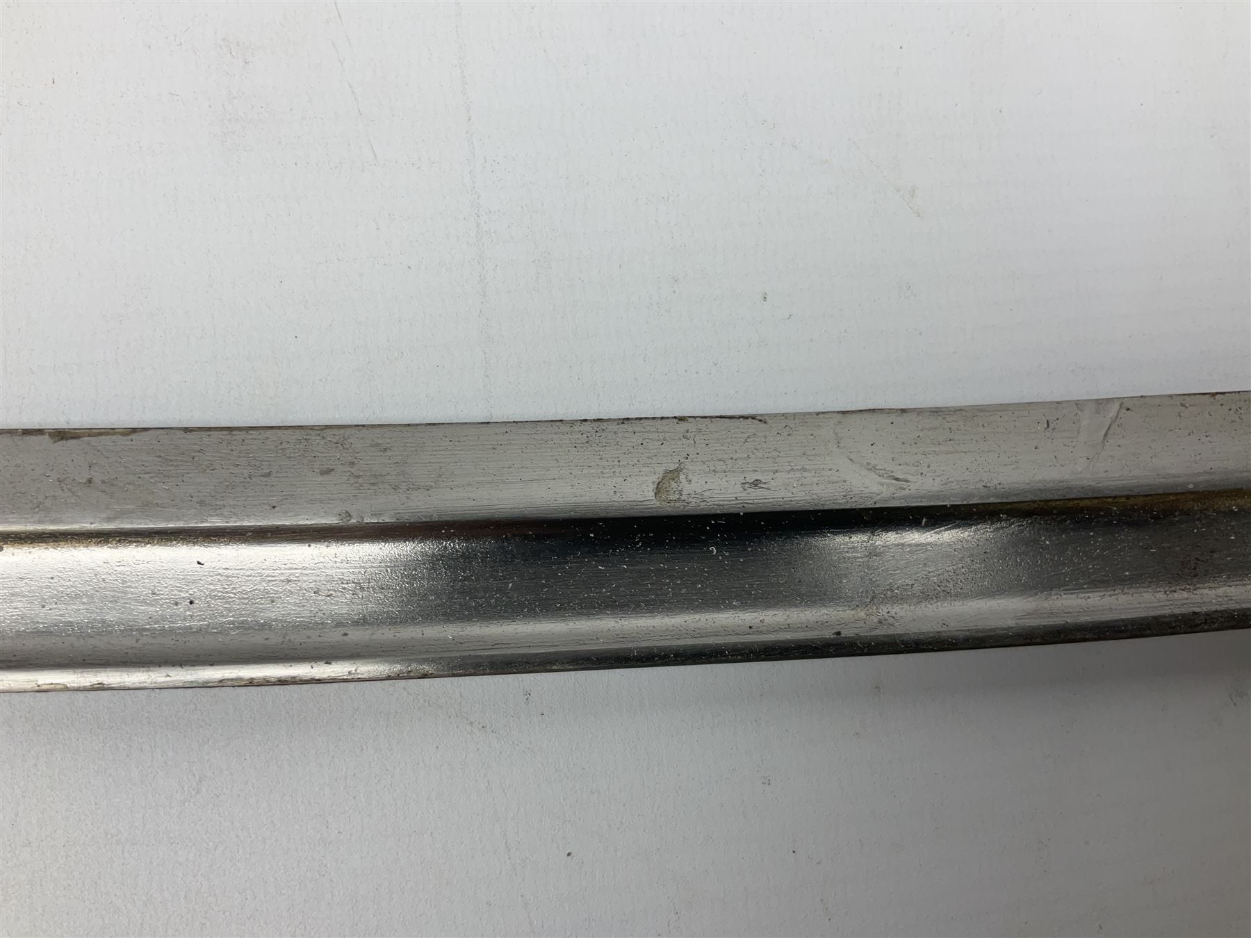 Turkish Model 1874 sword bayonet with 57.5cm curving steel fullered blade and chequered black grip, in steel mounted leather scabbard L75.5cm overall