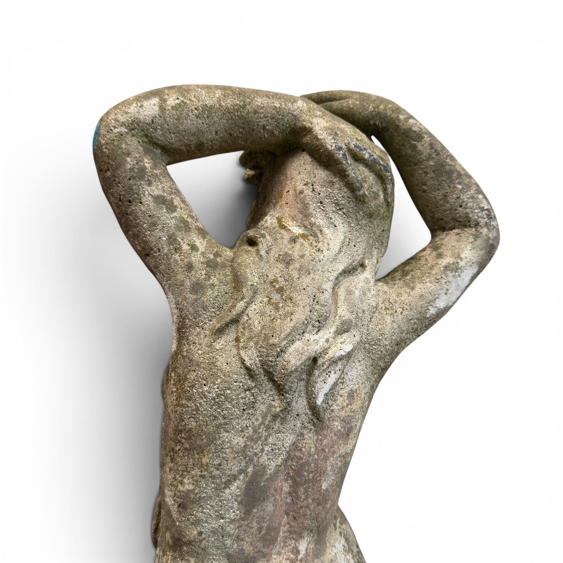Two composition stone garden figures, comprising a seated boy figure and a standing classical draped female figure, each on square base, weathered painted finish.
