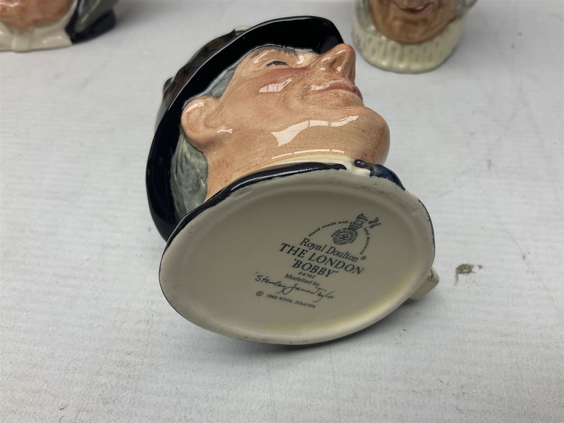 Large collection of Royal Doulton miniature character jugs, to include The Postman D6801, The London 'Bobby' D6762, Old Salt, D6554, Sir Henry Doulton D6703 etc  