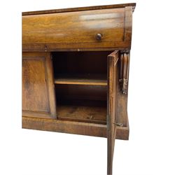 Victorian mahogany roll-top writing desk, top concealing fitted interior with pigeonholes and three drawers, the trisector inset writing surface with writing slope, base fitted with panelled cupboard enclosing single shelf, decorated with scrolled corbels