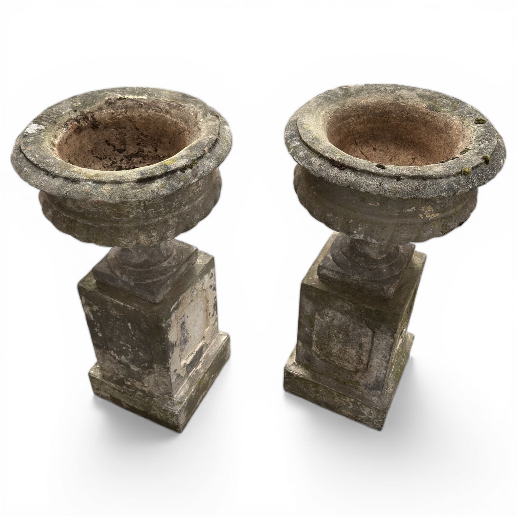 Pair of 20th century cast stone urns on plinths 