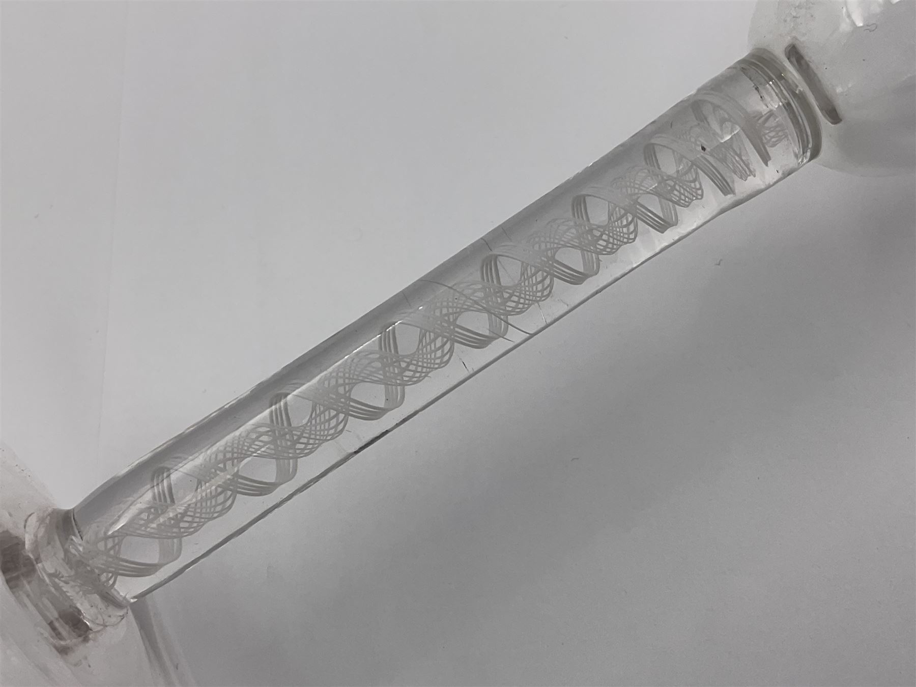 Set of three 18th century style wine glasses, each with funnel bowl etched with fruit vine, upon a double series air twist stem and circular foot, H17cm