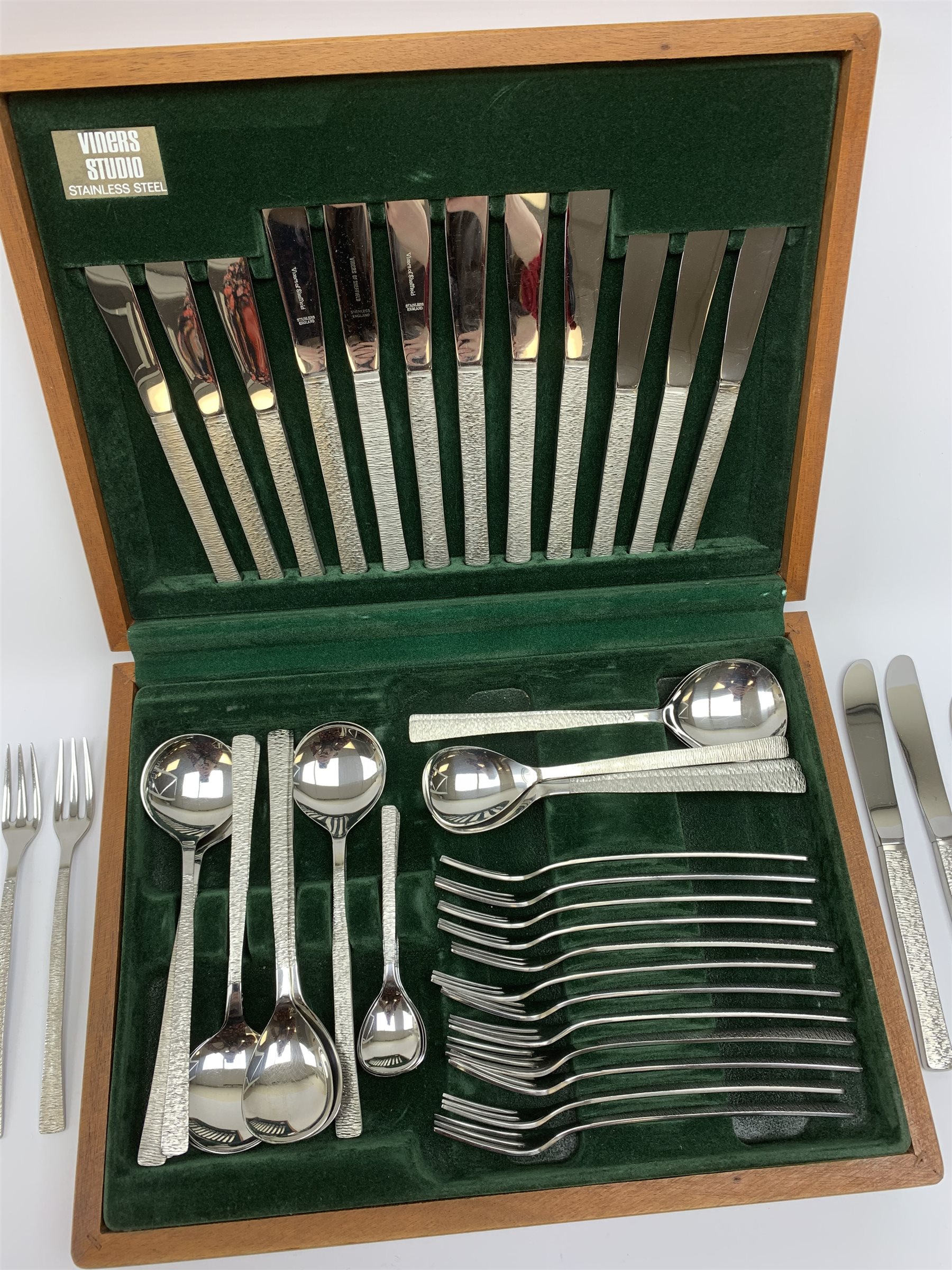 A canteen of bark effect stainless steel cutlery by Gerald Benney for Viners Studio, in a teak case. 