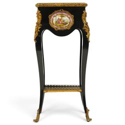 Early 20th century French ebonised sewing or work table, rectangular hinged top with foliate moulded gilt metal edge, enclosing upholstered interior, over a central Sevres style porcelain plaque depicting a courting scene, raised on cabriole supports with gilt metal carotuche and acanthus knee mounts, united by undertier with brass gallery terminating to gilt metal scroll feet
