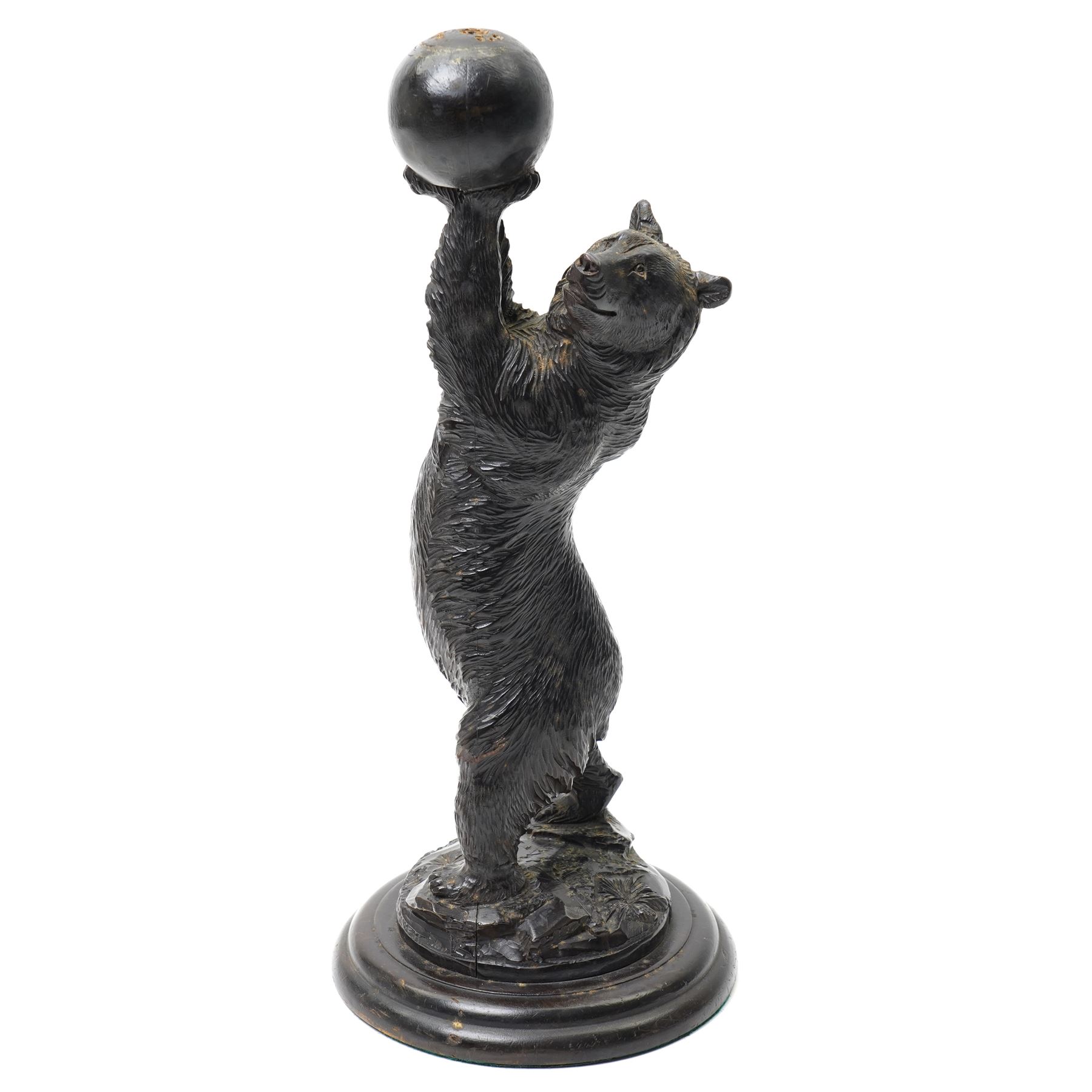 Black forest carving of a circus bear, holding aloft a ball, standing, H35cm