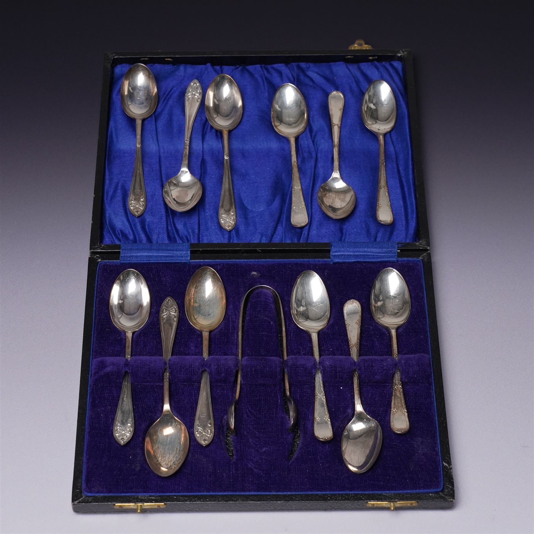 Set of  of six silver coffee spoons and tongs with bright cut decoration Sheffield 1908 Maker Cooper Bros. and another set of six coffee spoons with decorative terminals