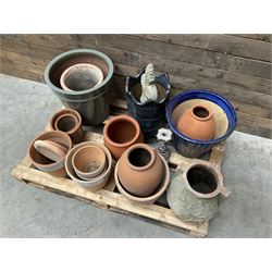 A quantity of various terracotta and glazed planters