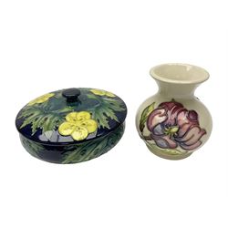 Moorcroft dish and cover, of circular form, decorated in Buttercup pattern, together with a Moorcroft vase, of baluster form, decorated in Magnolia pattern, both with printed marks beneath, tallest H9.5cm