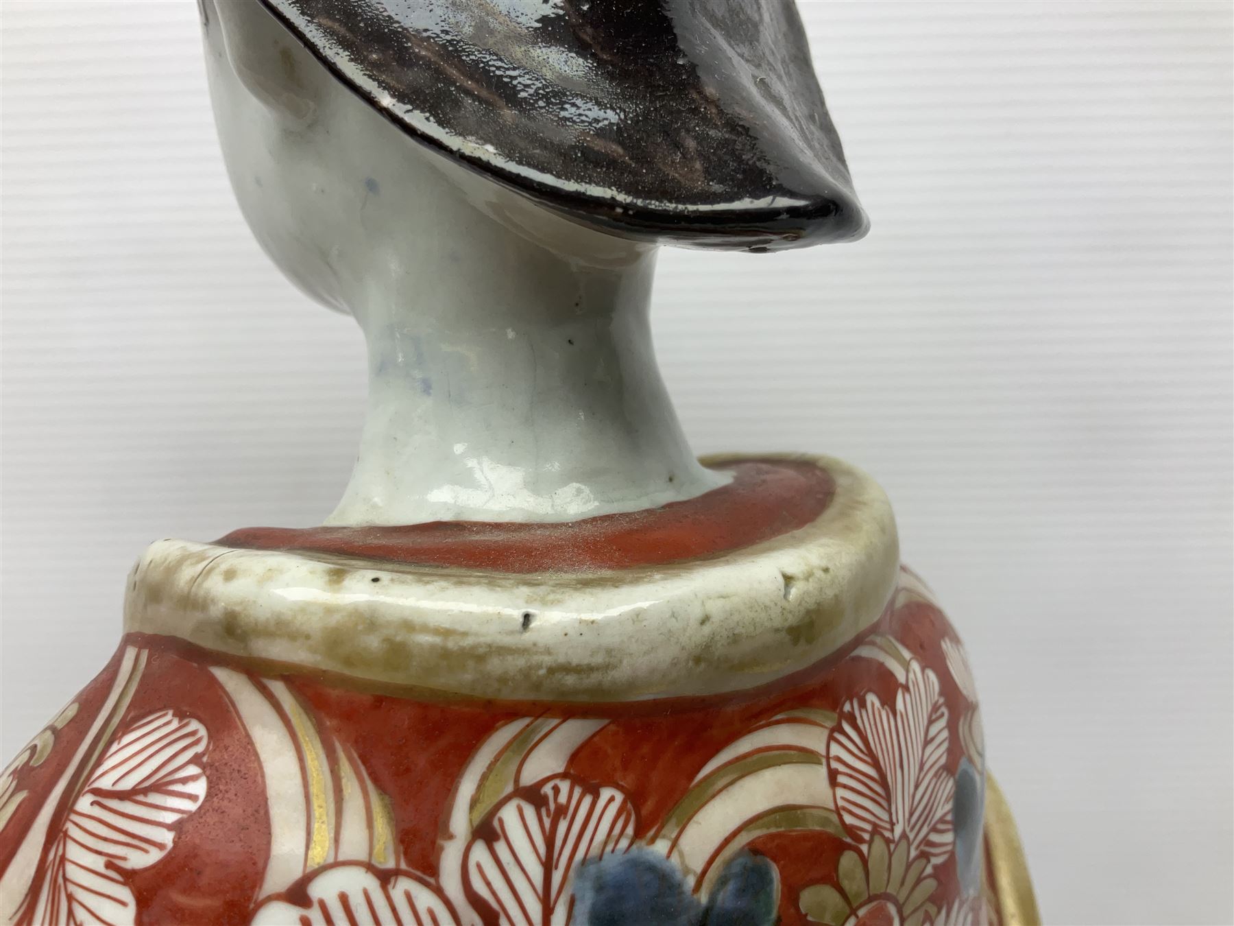 Large Japanese Imari porcelain figure, modelled as a Bijin, wearing a long kimono decorated with apple blossom and leafy branches on a white ground, with gilt detailing, possibly Edo period, H63cm