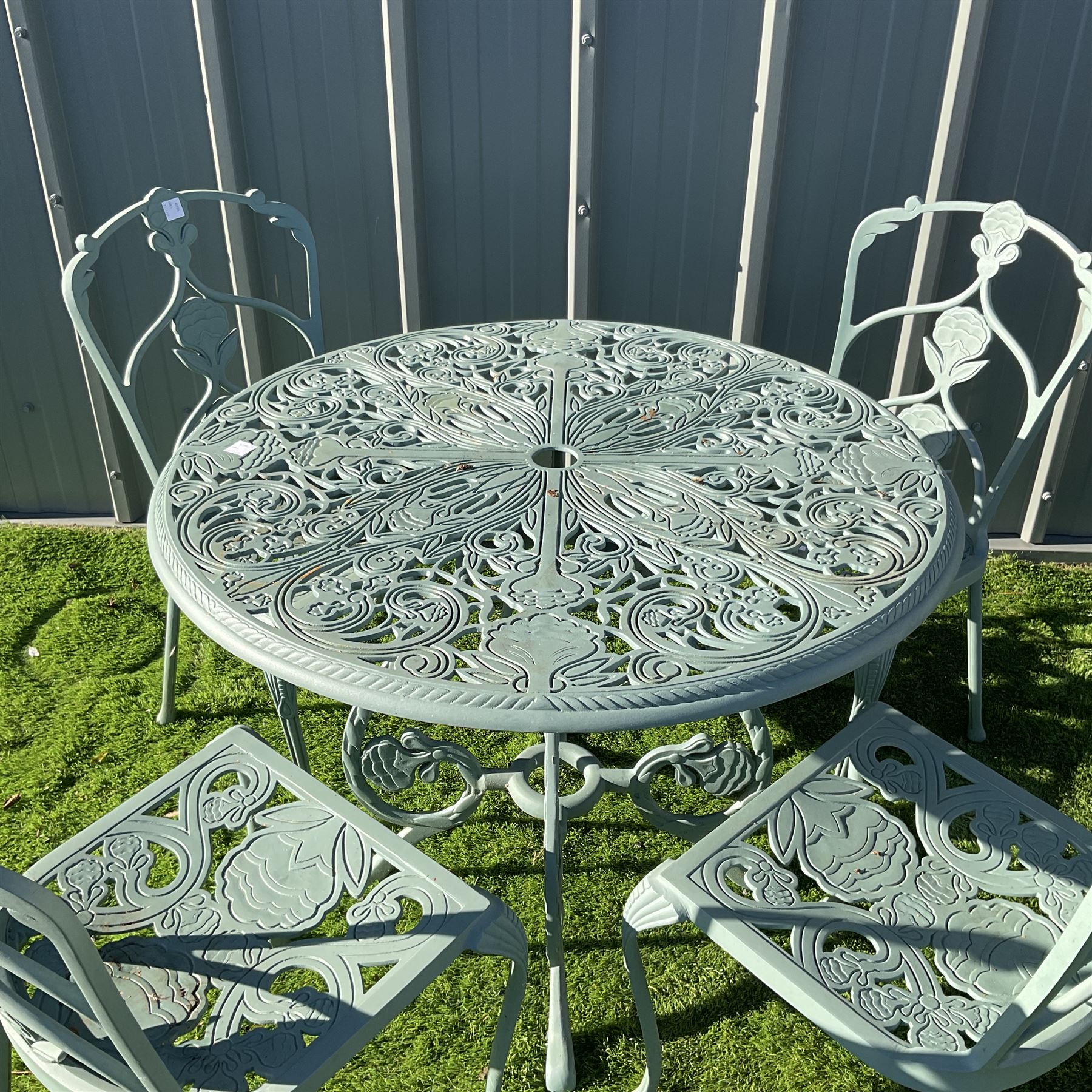 Painted cast aluminium circular garden table, and four chairs - THIS LOT IS TO BE COLLECTED BY APPOINTMENT FROM DUGGLEBY STORAGE, GREAT HILL, EASTFIELD, SCARBOROUGH, YO11 3TX