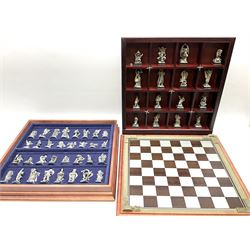 Danbury Mint 'The Fantasy of the Crystal' chess set consisting of mythical pewter chess pieces within a wooden case with chess board lid, together with 16 additional chess pieces in a wooden display case.